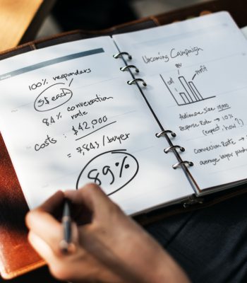 Woman writing and planning business strategy Woman writing and planning business strategy